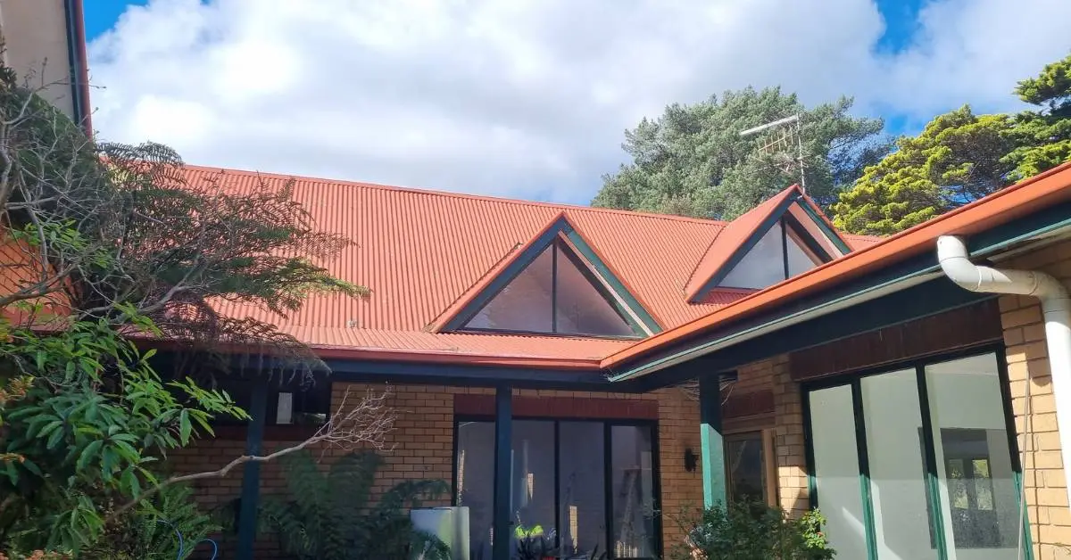 Commercial metal roof restoration — Dulux AcraTex membrane system, freshly finished — Roof Restoration Services Northern Suburbs Melbourne